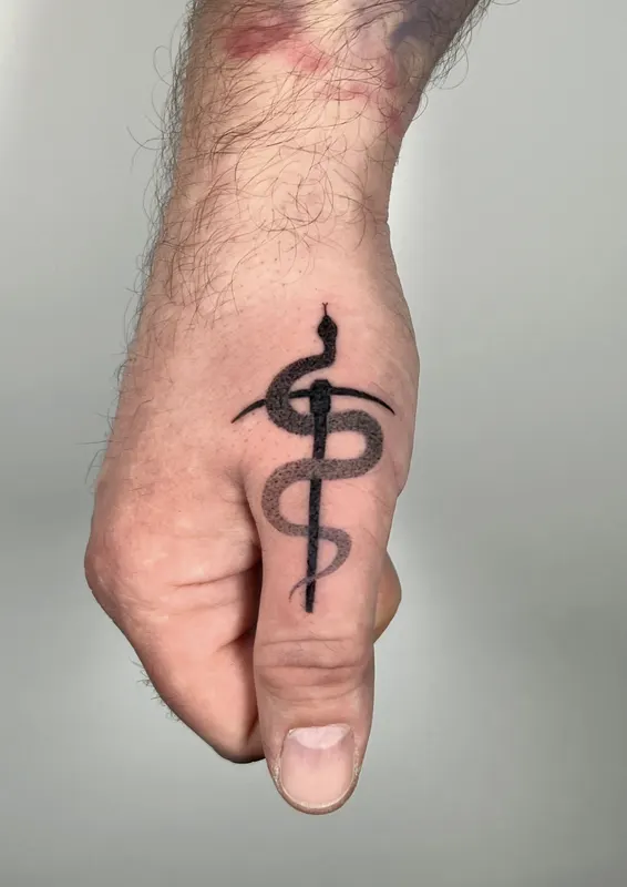 Fine line serpent and staff hand-poked on the hand