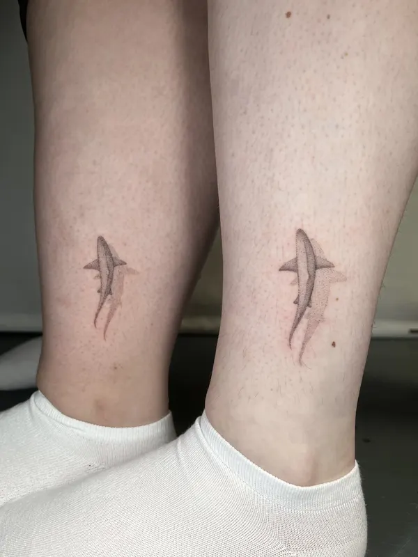 Matching fine line sharks hand-poked on both ankles