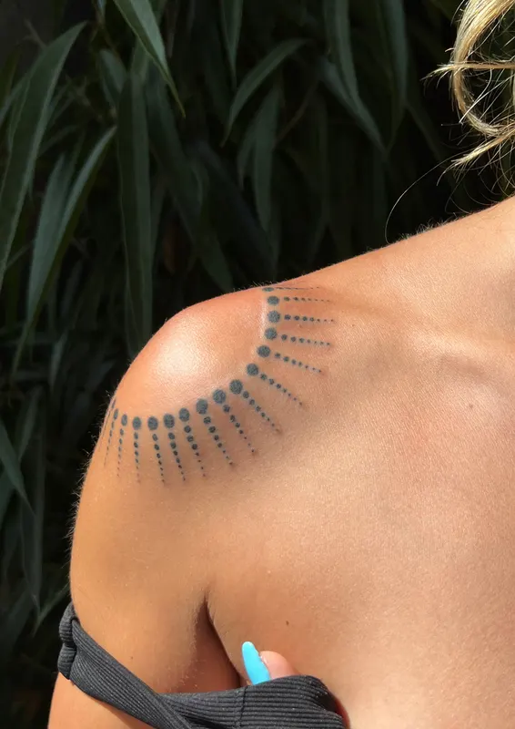 Ornamental dotwork draped over the shoulder