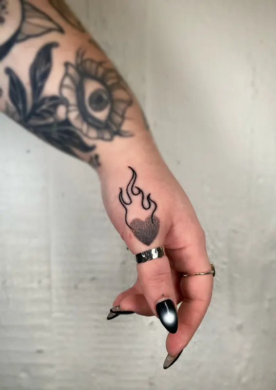 Hand-poked heart and flame finger adornments